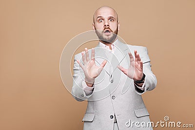 Portrait of scared stressed middle aged bald bearded businessman Stock Photo