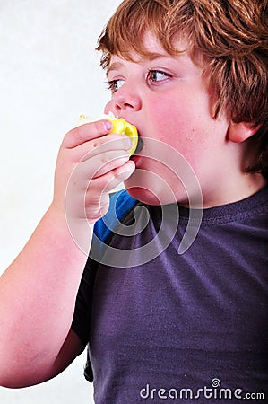 Portrait of schoolboy eating apple Stock Photo