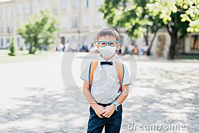 Portrait of schoolboy in glasses and butterfly wearing medicine mask Stock Photo