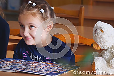 Portrait of a schoolgirl sitting at a Desk Editorial Stock Photo