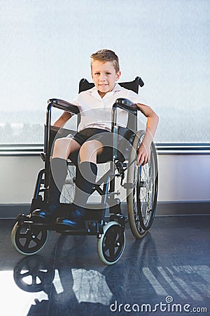 Portrait of schoolkid sitting on wheelchair Stock Photo