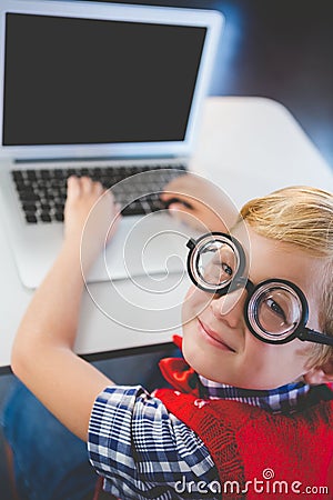 Portrait of schoolkid using laptop in classroom Stock Photo
