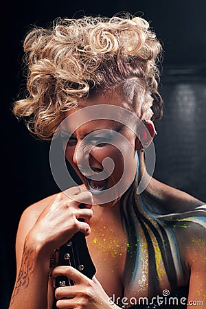 Portrait of screaming punk woman with body art Stock Photo
