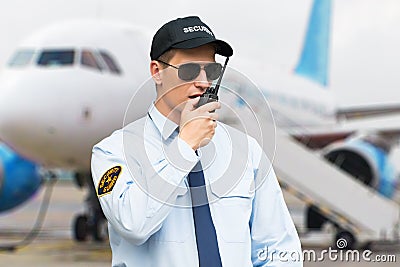 Portrait Of A Security Guard Talking On Walkie Talkie Stock Photo