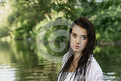 Portrait of a seductive girl posing with wet loose hair outdoors Stock Photo