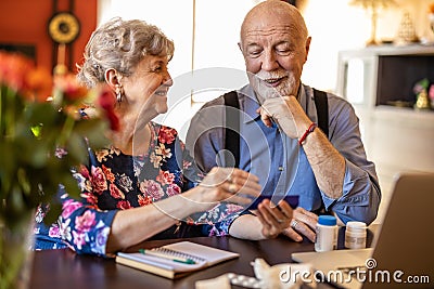 Senior couple reviewing drug prescription online Stock Photo