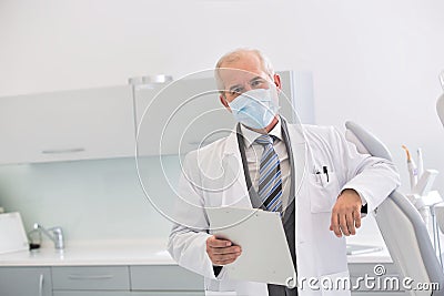 Portrait of senior dentist wearing mask at dental clinic Stock Photo