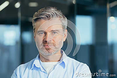 Portrait of senior experienced businessman, man thoughtfully looking at camera close up photo Stock Photo