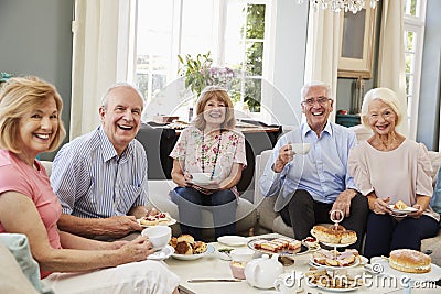 Portrait Of Senior Friends Enjoying Afternoon Tea At Home Stock Photo