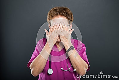 Portrait of senior lady doctor covering eyes like blind concept Stock Photo