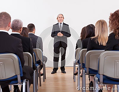 Portrait Of A Senior Manager Giving Presentation Stock Photo
