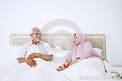 Senior muslim couple talking on bedroom Stock Photo