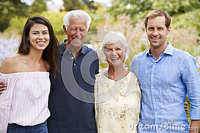 Portrait Of Senior Parents With Adult Children On Walk In Park Stock Photo