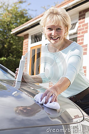 Portrait Of Senior Woman Polishing Car Stock Photo