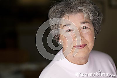 Portrait Of A Senior Woman Smiling At The Camera Stock Photo