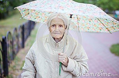 Portrait of senior woman under umbrella Stock Photo