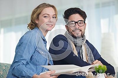 portrait sensible young couple looking at catalogue Stock Photo