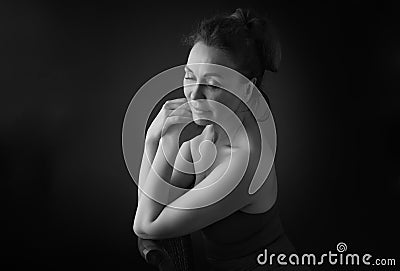 Portrait of a sensual fifty year old woman on grey studio background. Monochrome shot. Stock Photo