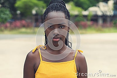 Portrait of serious african american young adult woman with dreadlocks Stock Photo