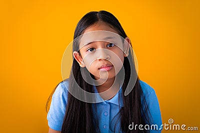 Portrait of serious asian cute girl orange background Stock Photo