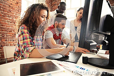 Portrait of a serious businesswoman using laptop in office. Beautiful hipster woman taking notes at modern office. Stock Photo