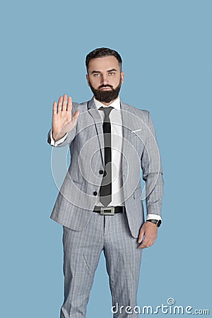 Portrait of serious office employee gesturing STOP, expressing denial on blue studio background Stock Photo