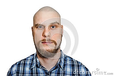 Portrait of a serious, pensive, bald guy with a beard with narrowed eyes looking at the camera on an isolated background Stock Photo