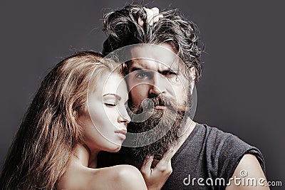 Portrait of sexy couple embracing. Bearded handsome man and female slim flexible body of young pretty sexy woman or girl Stock Photo