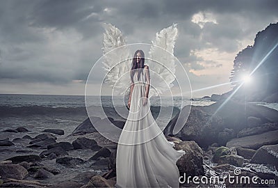 Portrait of the shining angel on the sharp rock Stock Photo