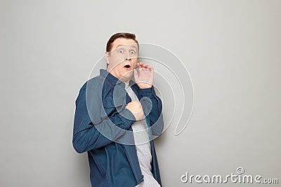 Portrait of shocked frightened man with widened eyes and opened mouth Stock Photo