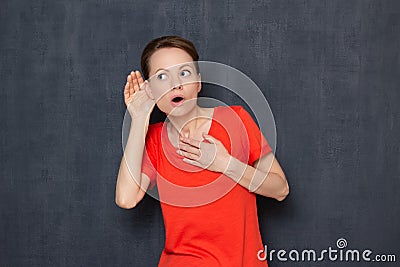 Portrait of shocked stunned young woman eavesdropping conversation Stock Photo