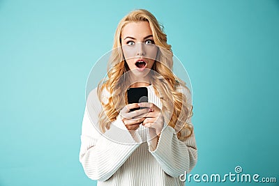 Portrait of a shocked young blonde woman in sweater Stock Photo