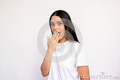 Portrait of shocked young woman covering mouth with hand Stock Photo