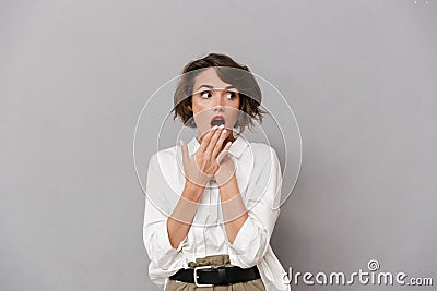 Portrait of a shocked young woman dressed in white shirt Stock Photo