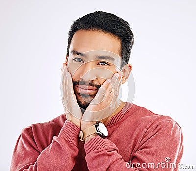 Portrait, shy and in love with a man in studio isolated on a white background while touching his cheeks. Face, coy and Stock Photo