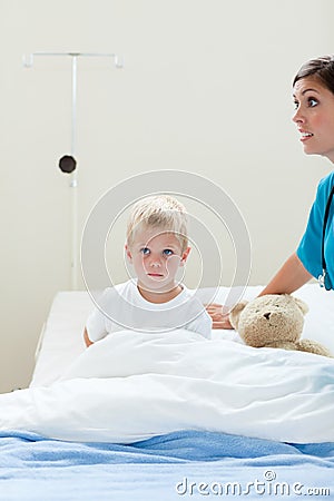 Portrait of a sick little boy on a hospital bed Stock Photo