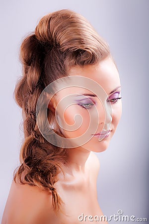 portrait sideview of blonde girl in elegant whimsical coiffure Stock Photo