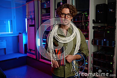 Portrait of signalman with many wires on shoulders and laptop in hand Stock Photo