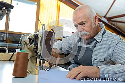 portrait skilled senior tailor Stock Photo