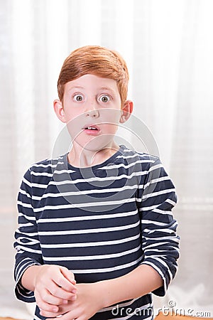 Portrait small boy scared with eyes wide open Stock Photo