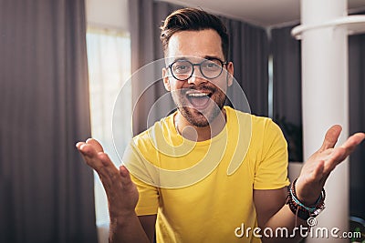 Smart confident smiling millennial man standing at home Stock Photo