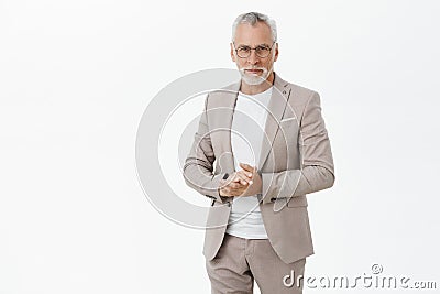 Portrait of smart and handsome intelligent senior male professor in stylish suit and glasses holding hands together Stock Photo