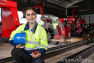 Portrait smart Indian lady engineer woman supervisor worker wear reflective safety suit work in robot metal machinery factory Stock Photo