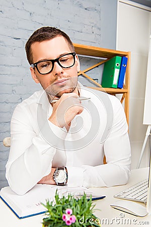 Portrait of smart minded businessman in glasses thinking about new project Stock Photo