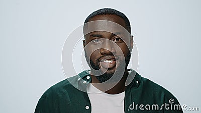 Portrait of smiling african handsome raising head in grey background. Stock Photo