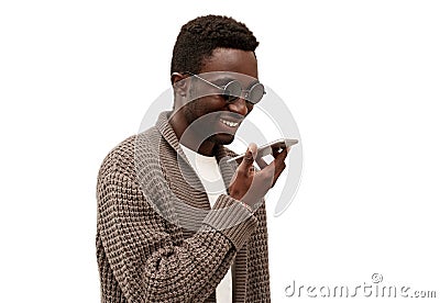 Portrait smiling african man with smartphone using voice command recorder, assistant or takes calling isolated on a white Stock Photo