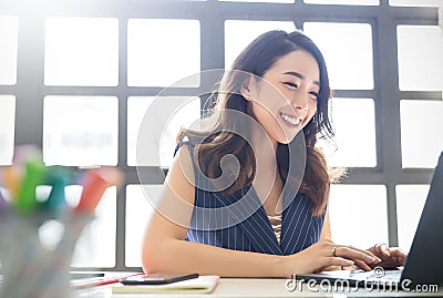 Portrait of smiling beautiful business asian woman with suit working in office deskà¹ƒ Stock Photo