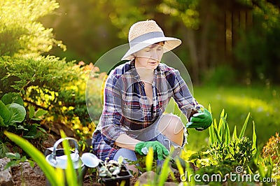 Portrait of smiling beautiful middle age female gardener Stock Photo