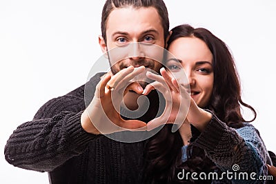 Portrait of smiling beauty girl and her handsome boyfriend making shape of heart by their hands. Stock Photo