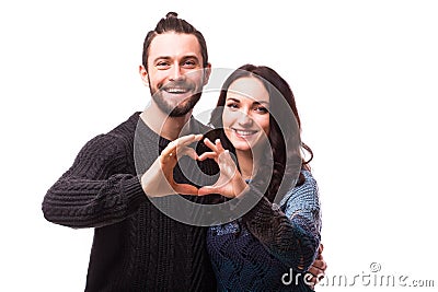 Portrait of smiling beauty girl and her handsome boyfriend making shape of heart by their hands. Stock Photo